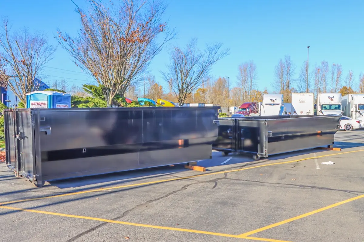Professional dumpster rental service with roll-off container on residential driveway in Ontario